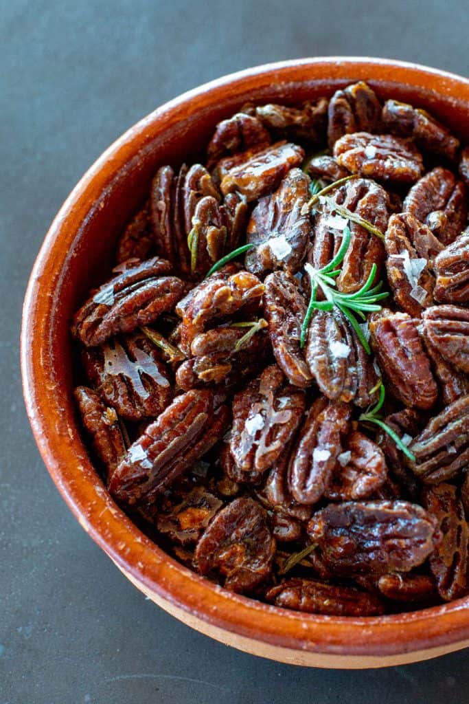 close up of a bowl of rosemary maple roasted pecans