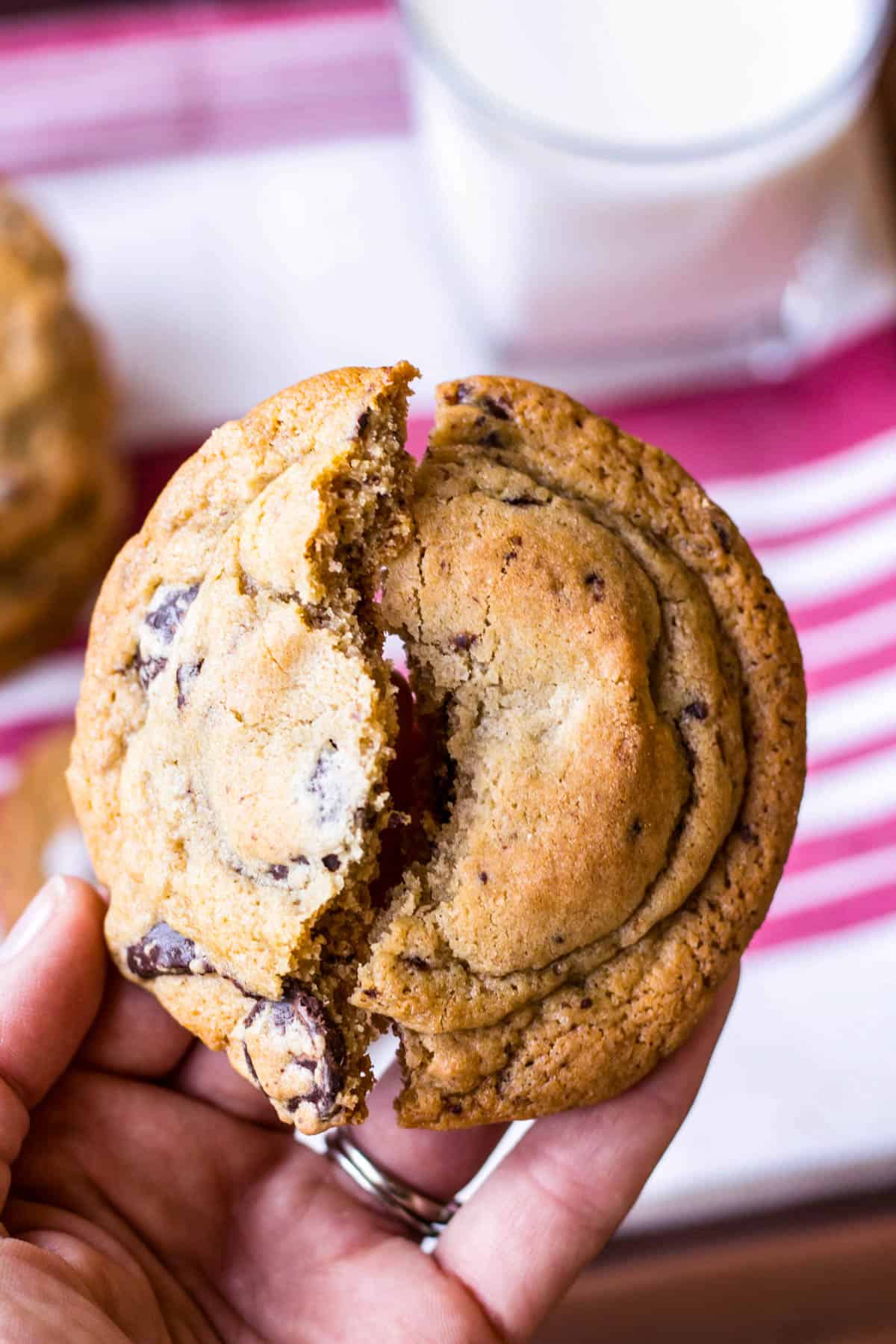 Extreme closeup of a chocolate chunk cookie being split in half.