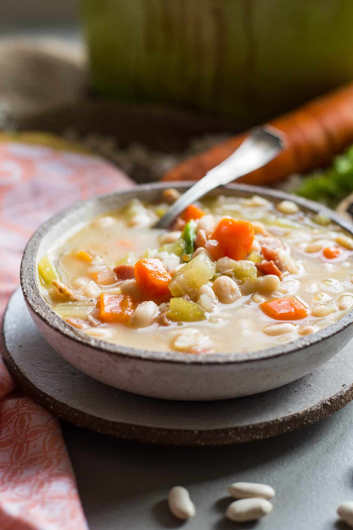 side view of a bowl of bean soup with a spoon