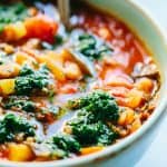 close up of vegetable minestrone soup with parsley pistou herb drizzle