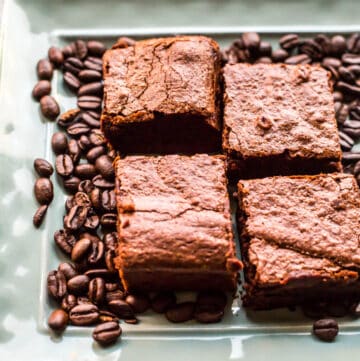 overhead shot of Espresso Brownies on light blue plate with coffee beans