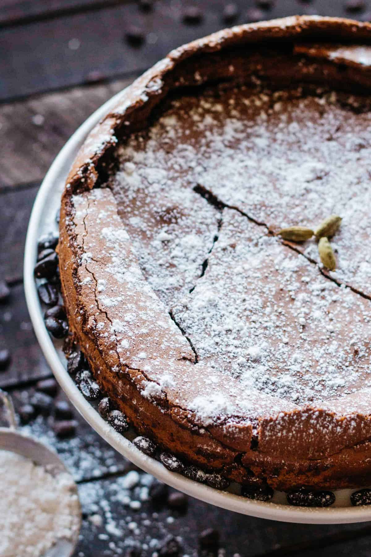 Top view of a flourless chocolate cake with powdered sugar sifted over the top.