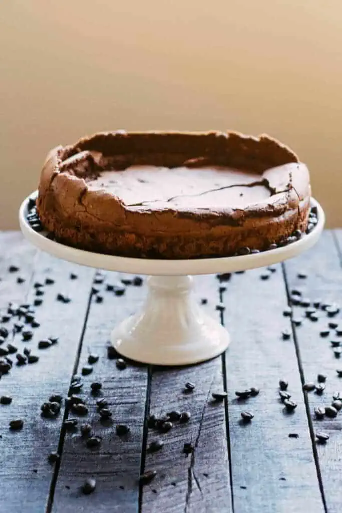 Flourless chocolate cake on a cake stand.