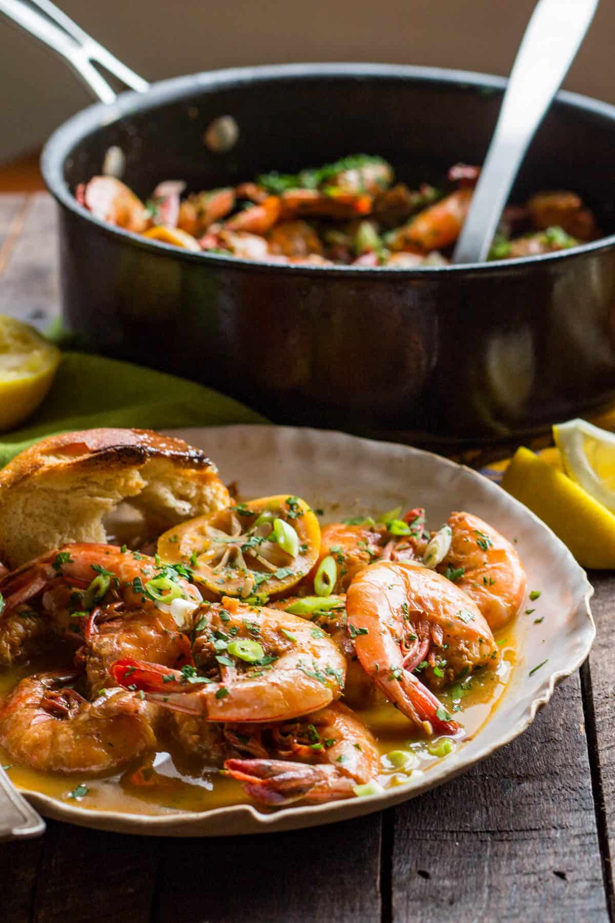 side view of a plate of shell on shrimp with a pan in the background