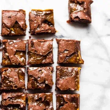 overhead view of brownies cut into squares with the top right one pulled aside