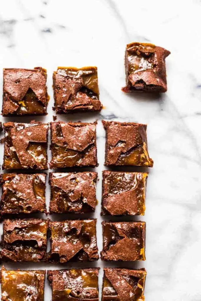 overhead view of brownies cut into squares with the top right one pulled aside