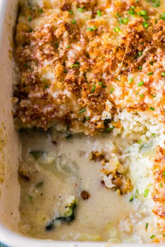 zucchini gratin in a casserole dish with a serving taken out