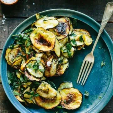 Fork next to roasted zucchini rounds.