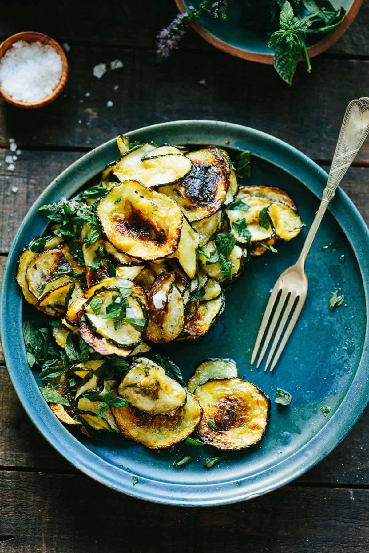 Fork next to roasted zucchini rounds.