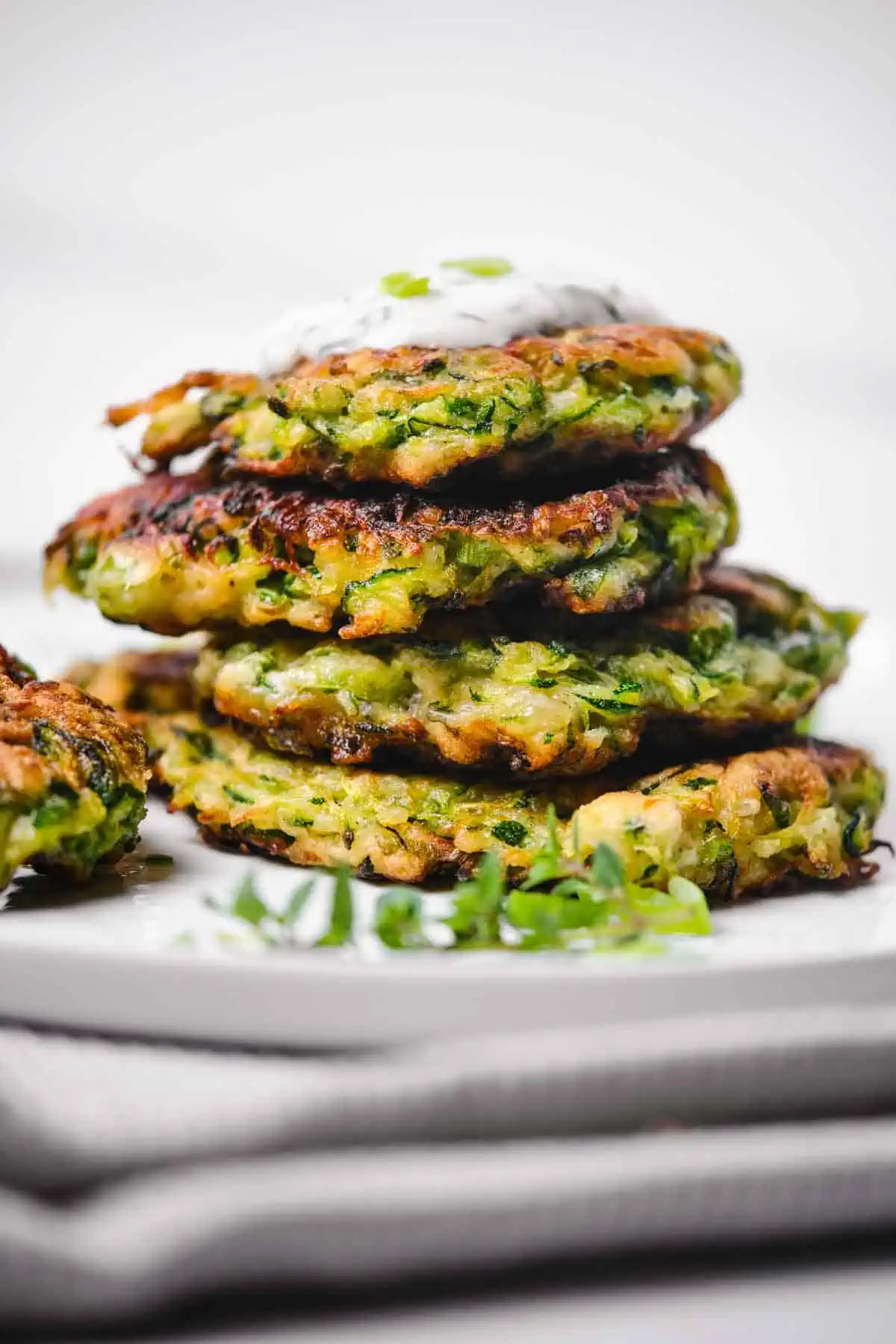 Side view of a stack of zucchini fritters.