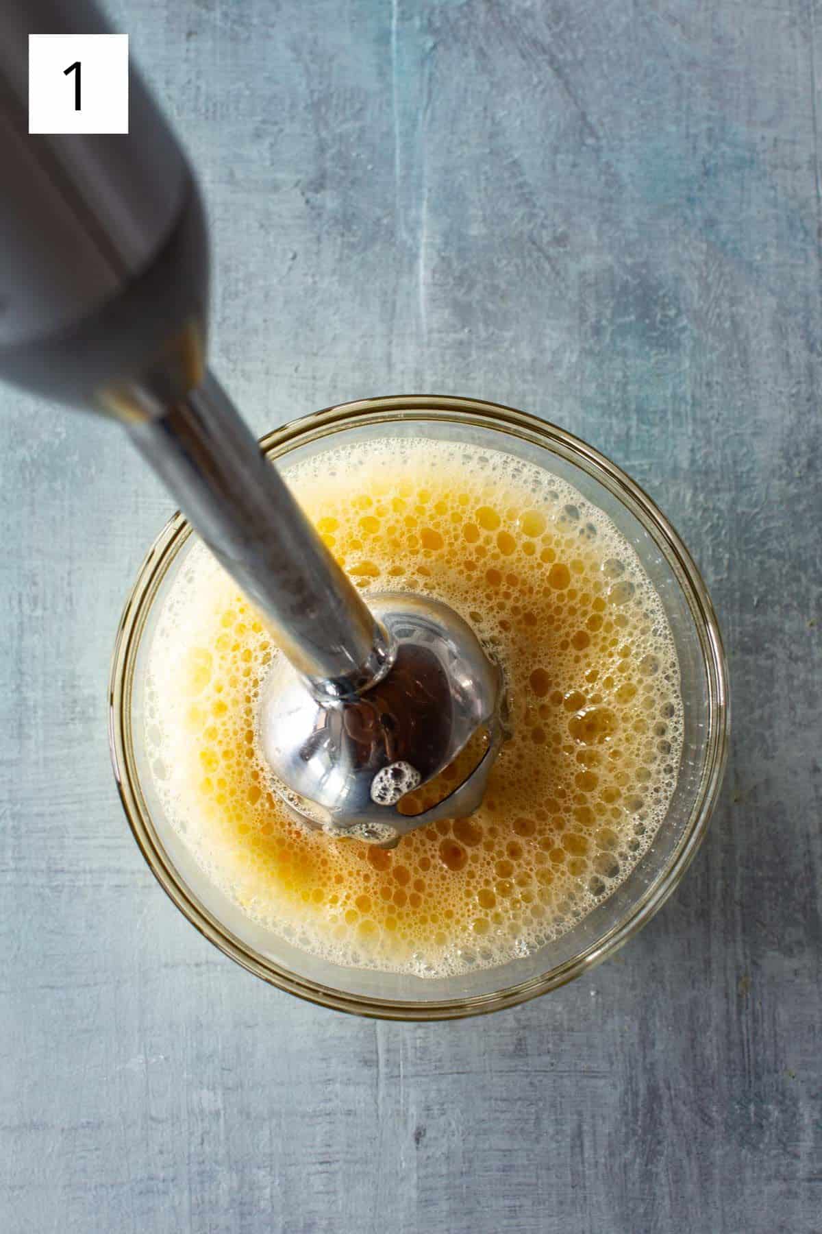 an immersion blender whisking eggs
