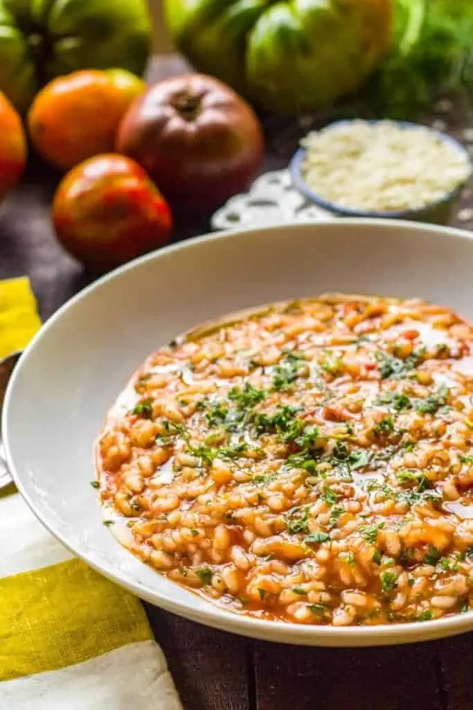 Shallow bowl filled with tomato fennel risotto.