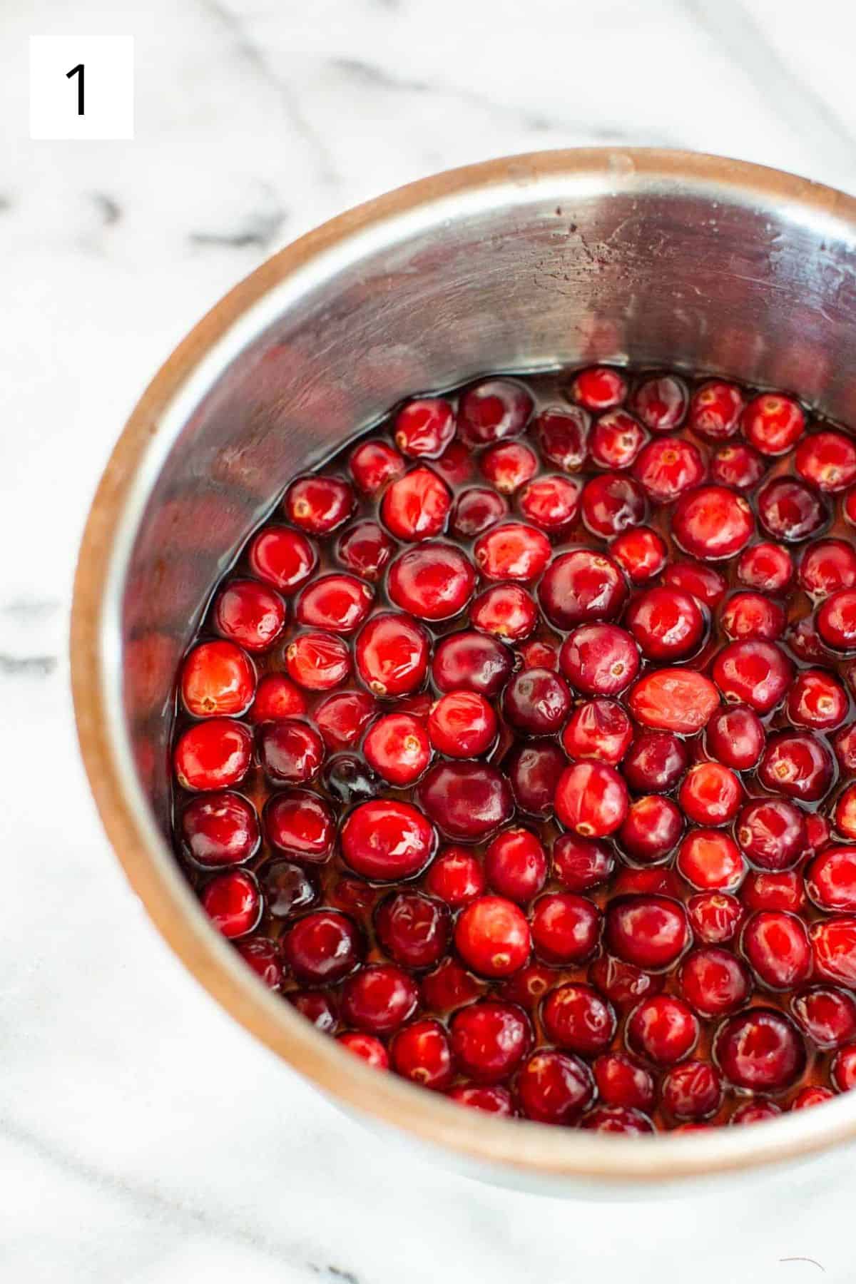 Cranberries simmering in a pot.