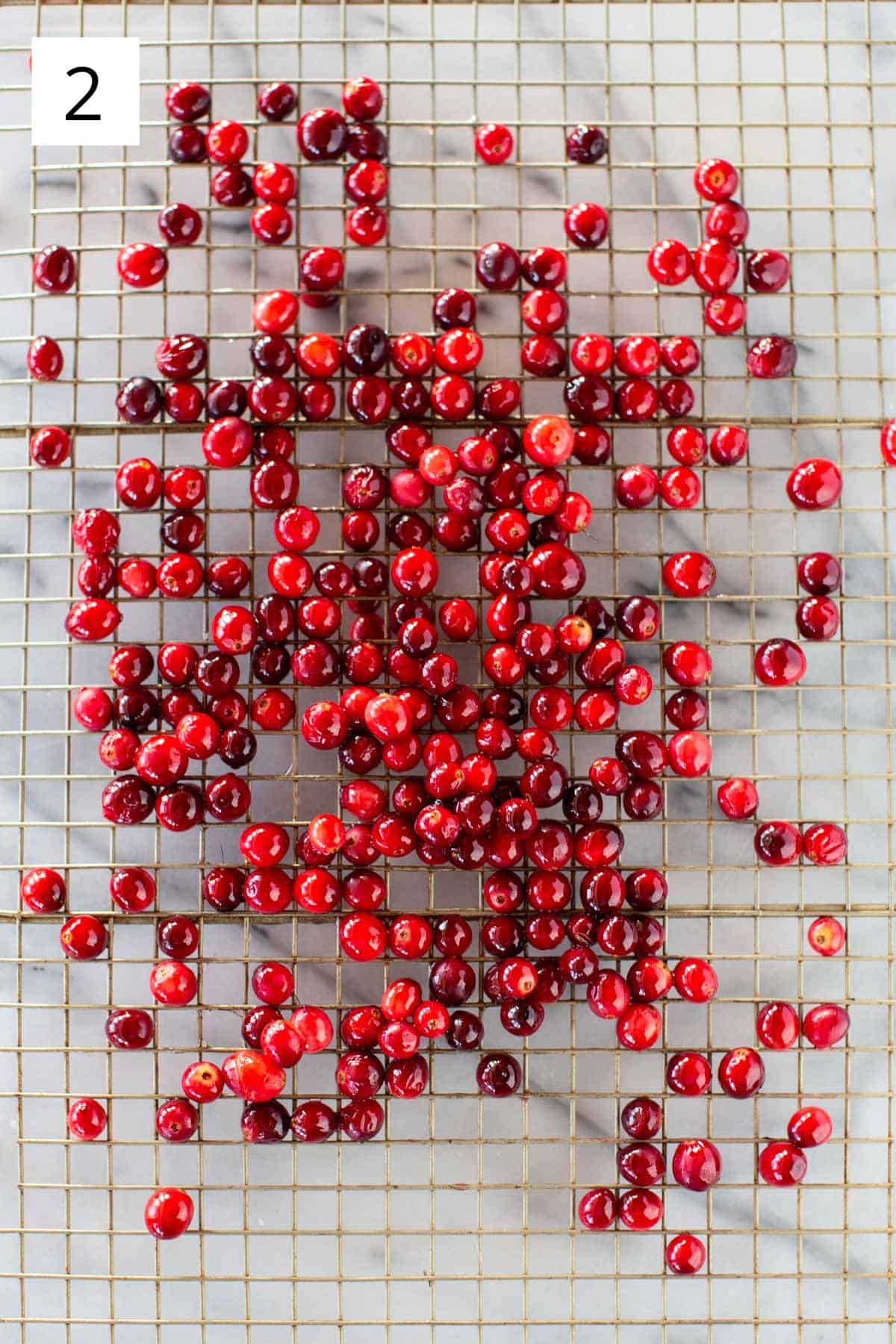 Overhead shot of cranberries on a drying rack.