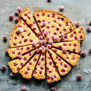 Overhead shot of a sliced tart with cranberries dotted throughout.
