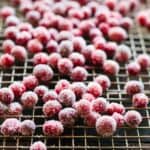 Sugared cranberries on a drying rack.