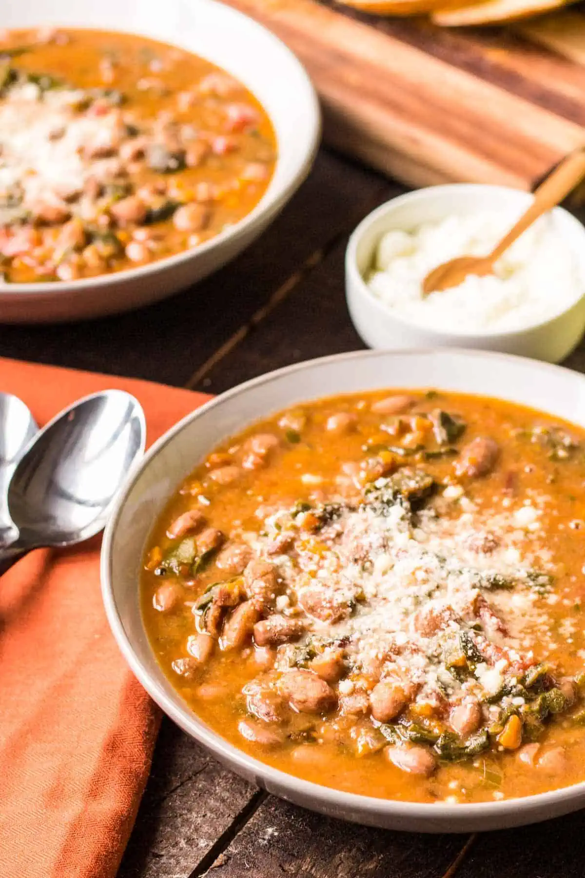 A bowl of Ribollita Tuscan soup with a spoon next to it.
