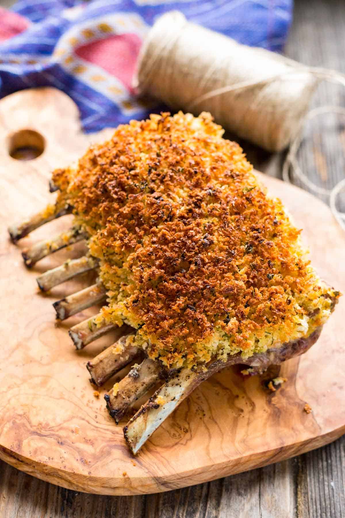 A rack of lamb coated with herb dijon and crusted in the oven.