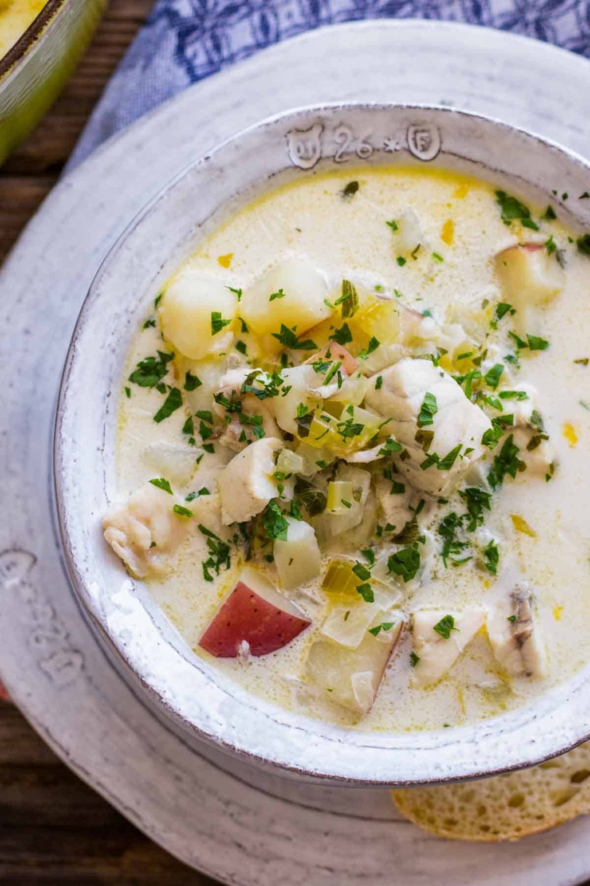 Overhead close up shot of a bowl of New England fish chowder.