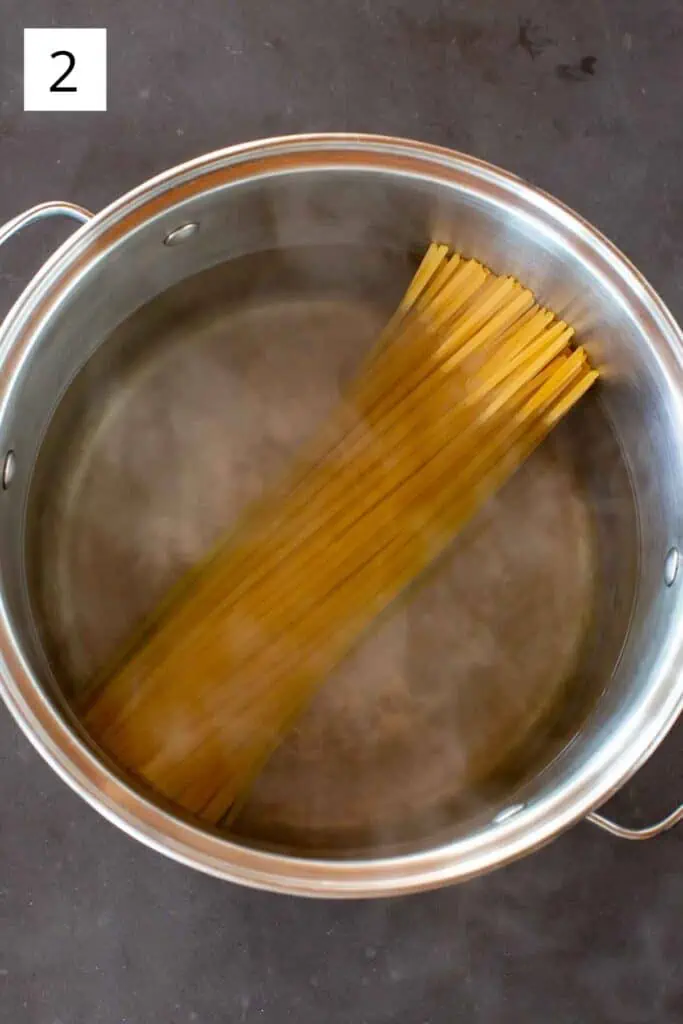 Linguine in a pot of boiling water.