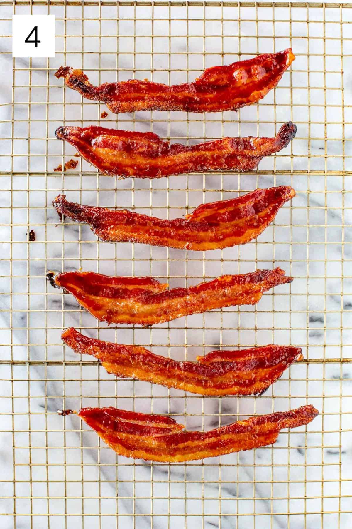 Top view of bacon cooling on a wire rack.