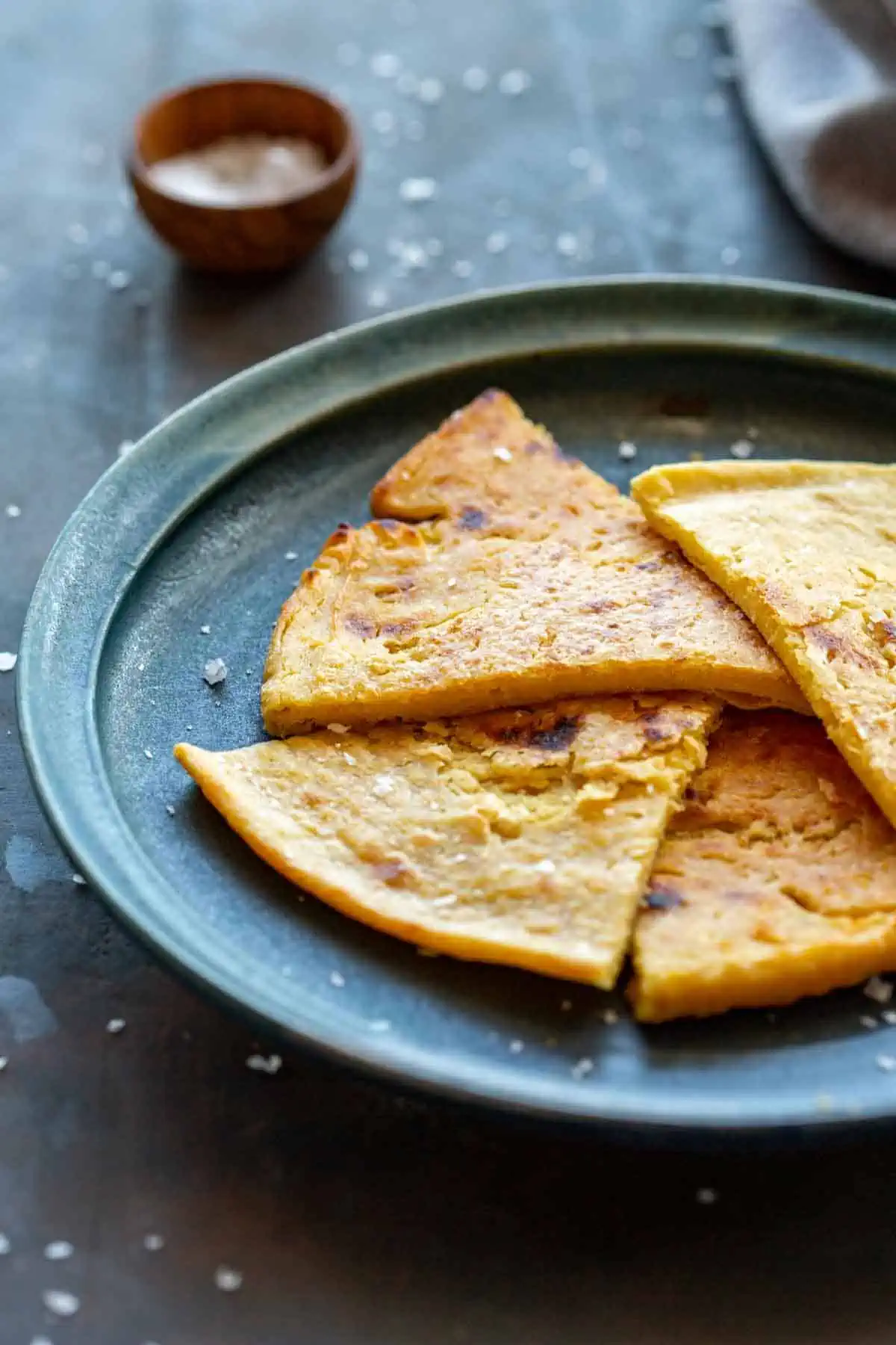 Close up of cut wedges of a chickpea pancake. 