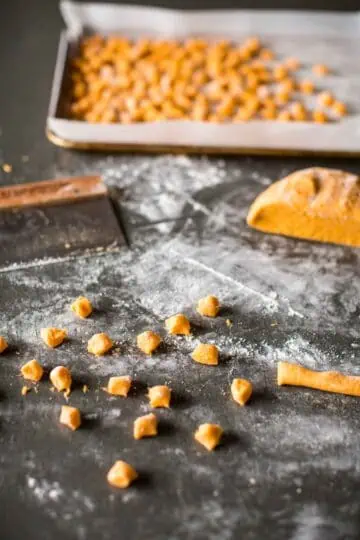 Cutting rolled dough into sweet potato gnocchi.