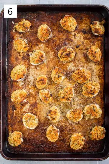 Baked clams oreganata on a baking sheet.