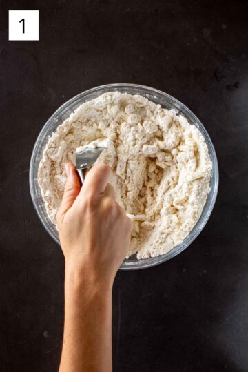 Combining flour, salt, sugar, and shortening with a pastry cutter. 