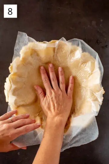 Pressing Crisco pie crust into baking dish with wax paper. 