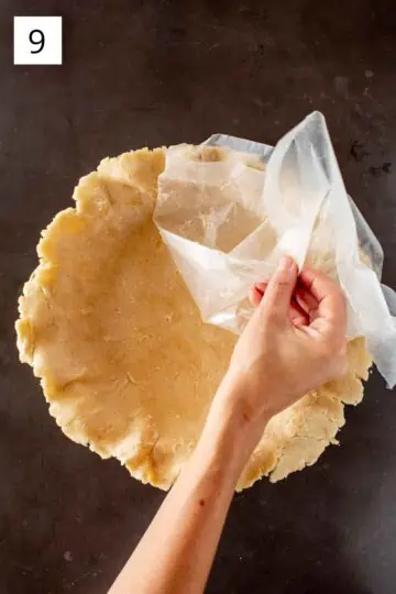 Removing wax paper from dough. 