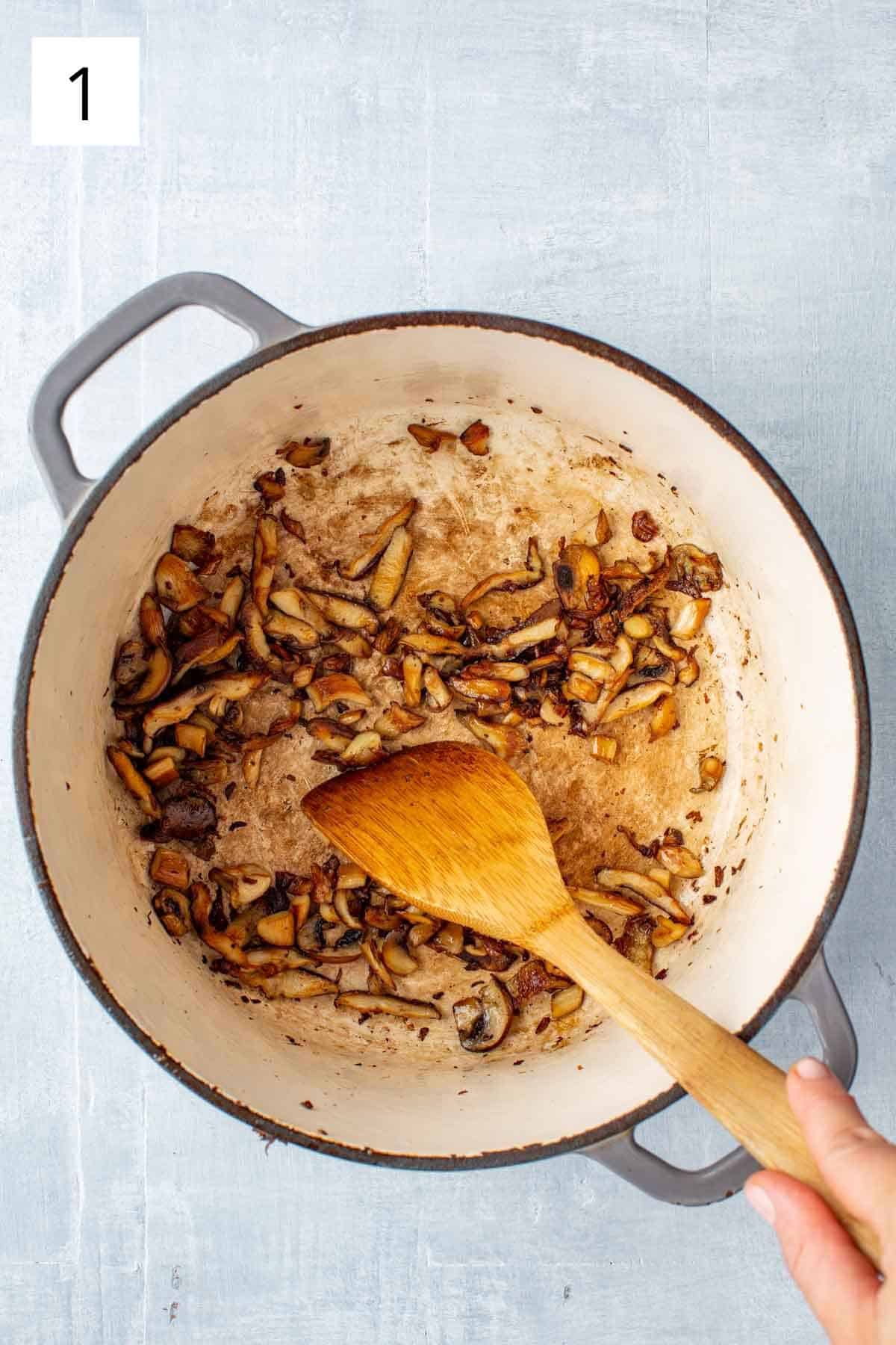 Sautéing mushrooms in a bit of olive oil.