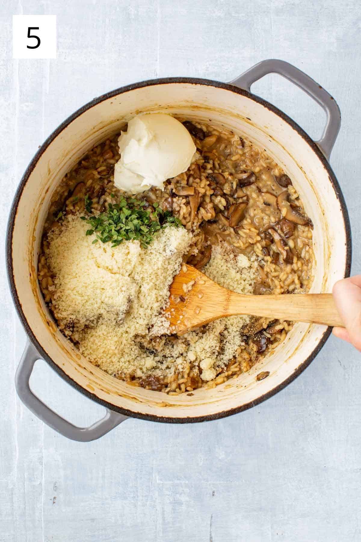 Adding mascarpone cheese, thyme, and parmesan to a risotto recipe.