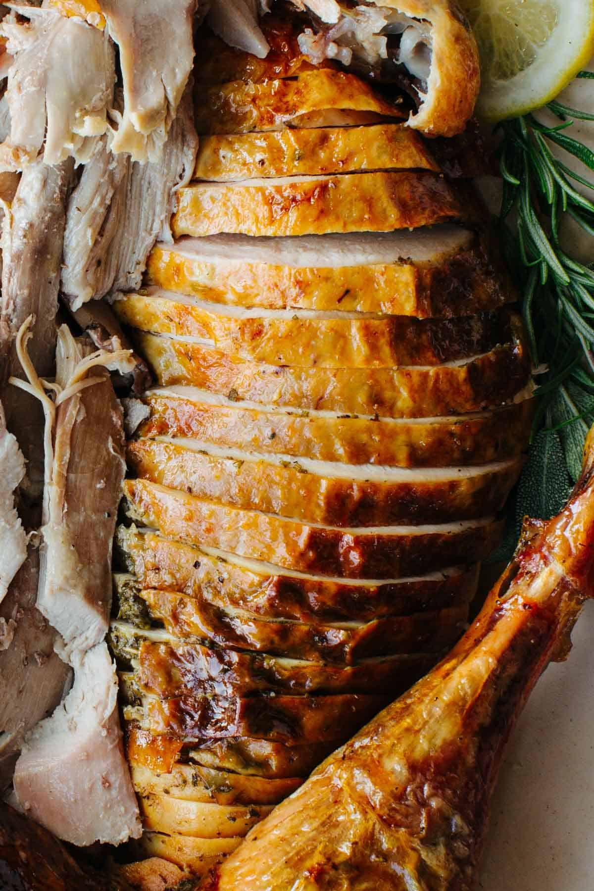 Perfectly carved turkey, rosemary and lemon slices. 