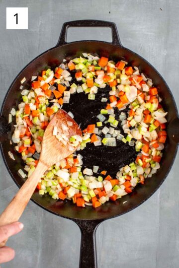 Sautéing carrots, celery and onion in a skillet.