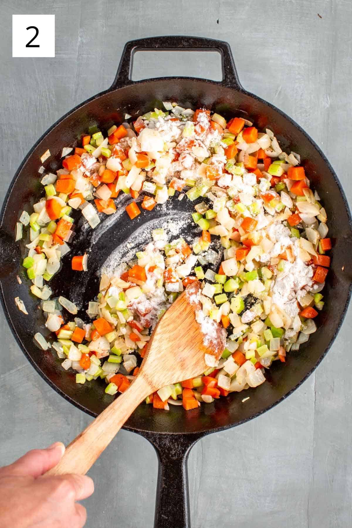 Stirring flour into sautéed vegetables.