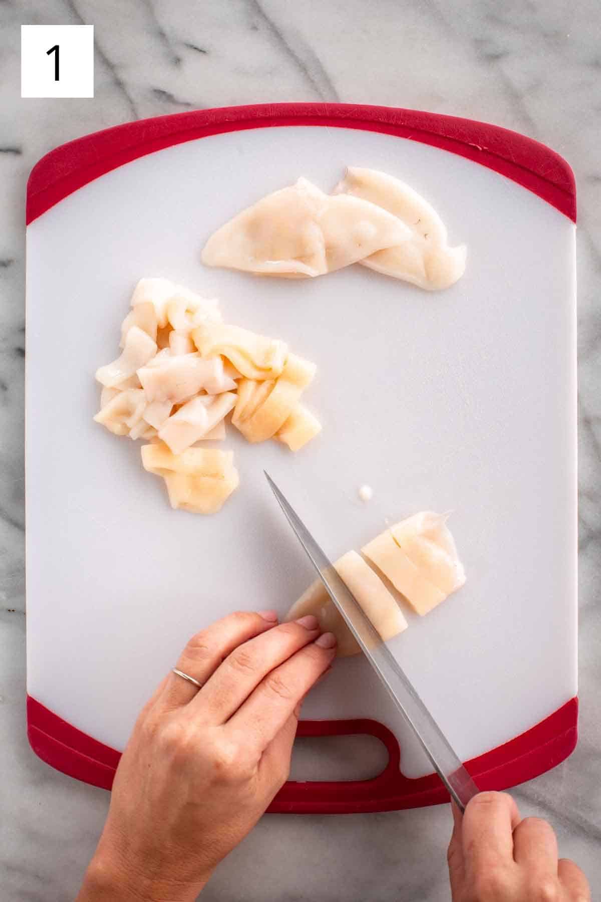 Slicing up fresh squid for cooking.