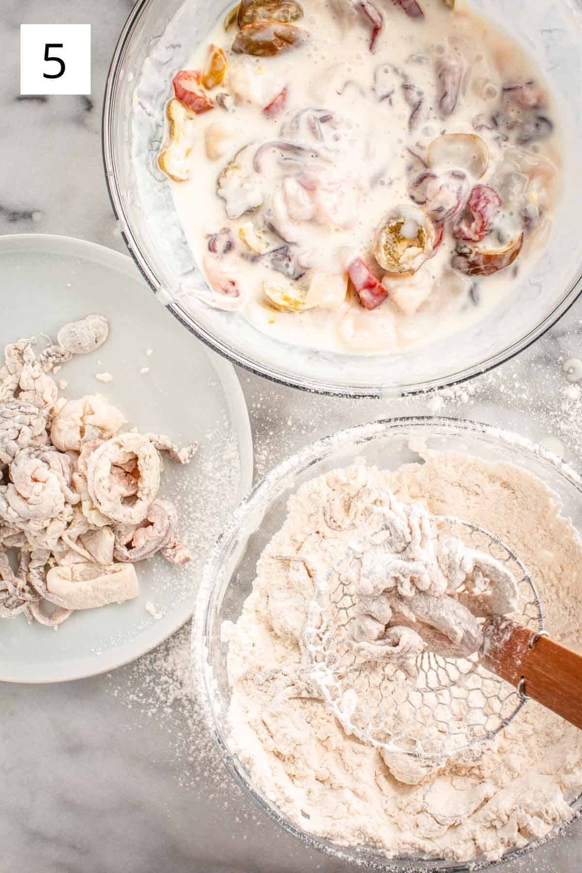 Coating squid pieces in flour mixture.