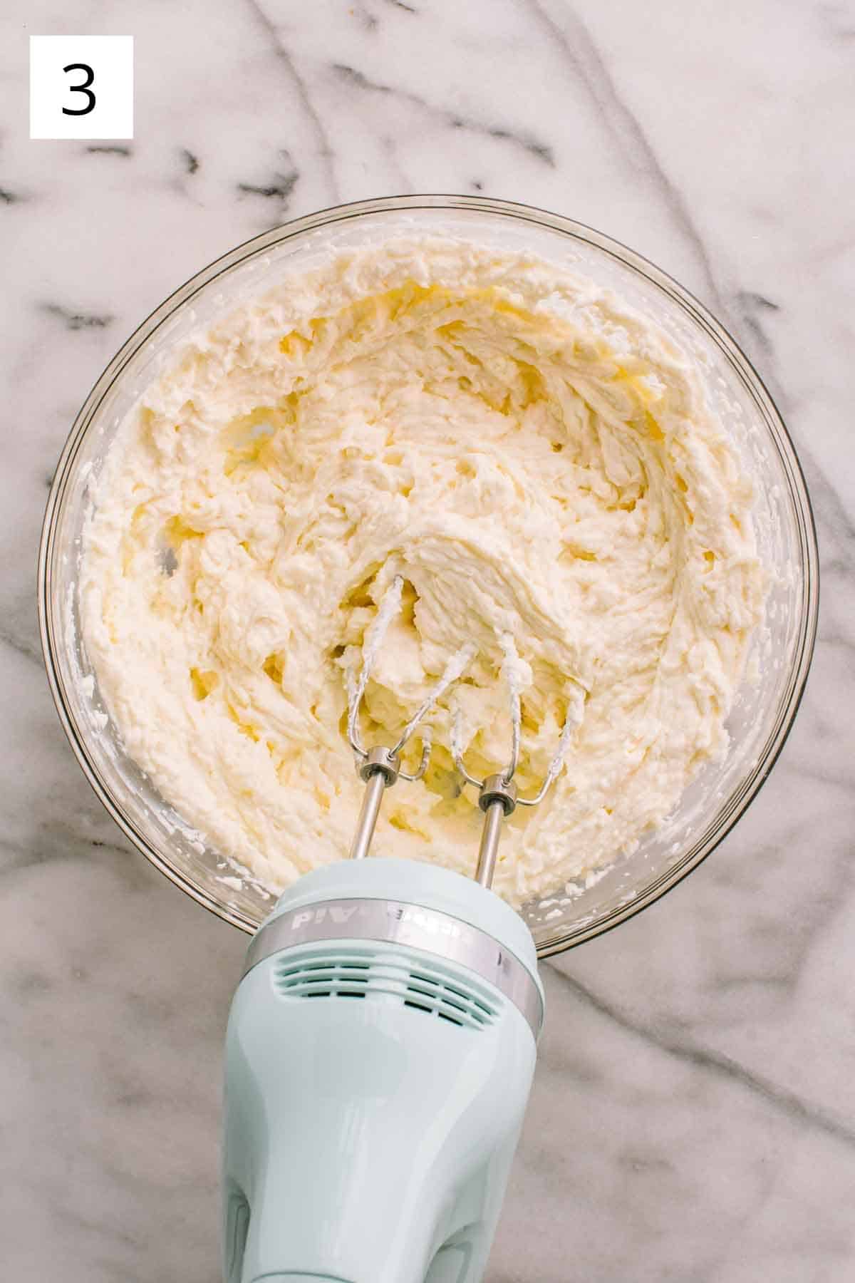 Mixing together filling with a hand mixer.