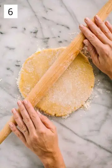 Rolling out pastry dough with a French rolling pin.