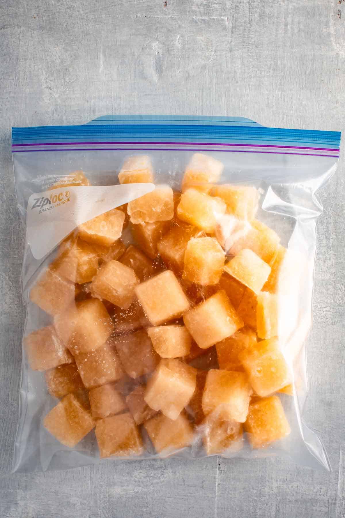 A zip top bag filled with turkey stock ice cubes.