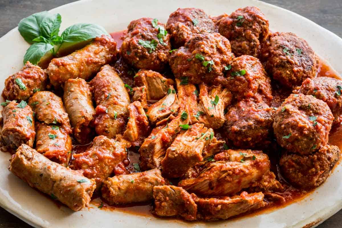 A platter of assorted meats cooked in Italian red gravy.