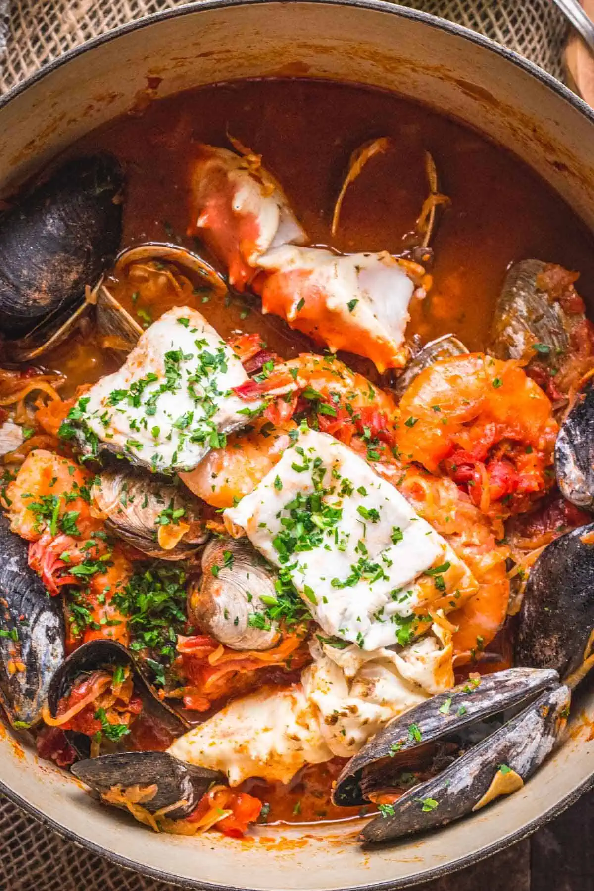 Close up of a Dutch oven filled with seafood Cioppino.