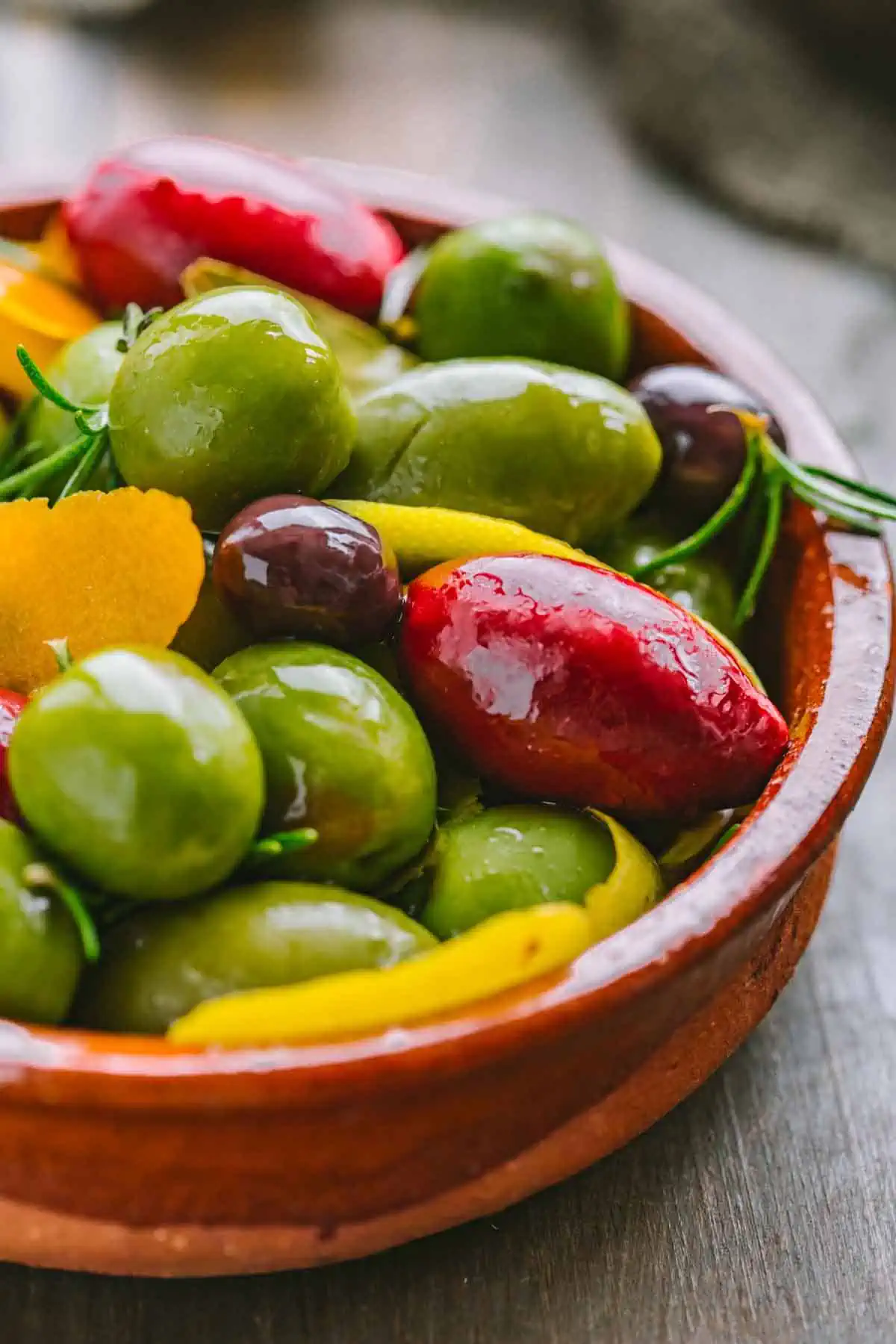 A Spanish style bowl filled with assorted olives.