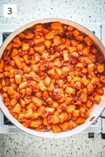 Sweet potato and bacon hash in a frying pan.