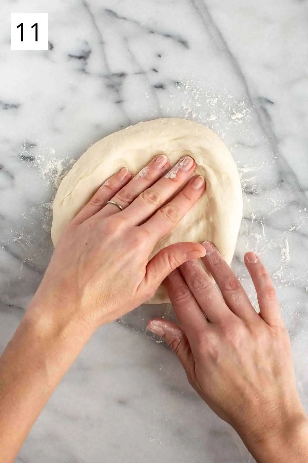 Stretching pizza dough by hand.