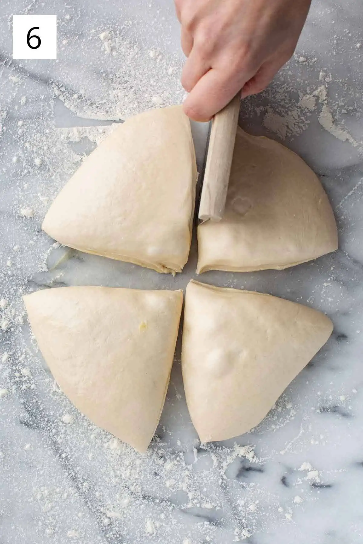Separating dough into four equal parts.