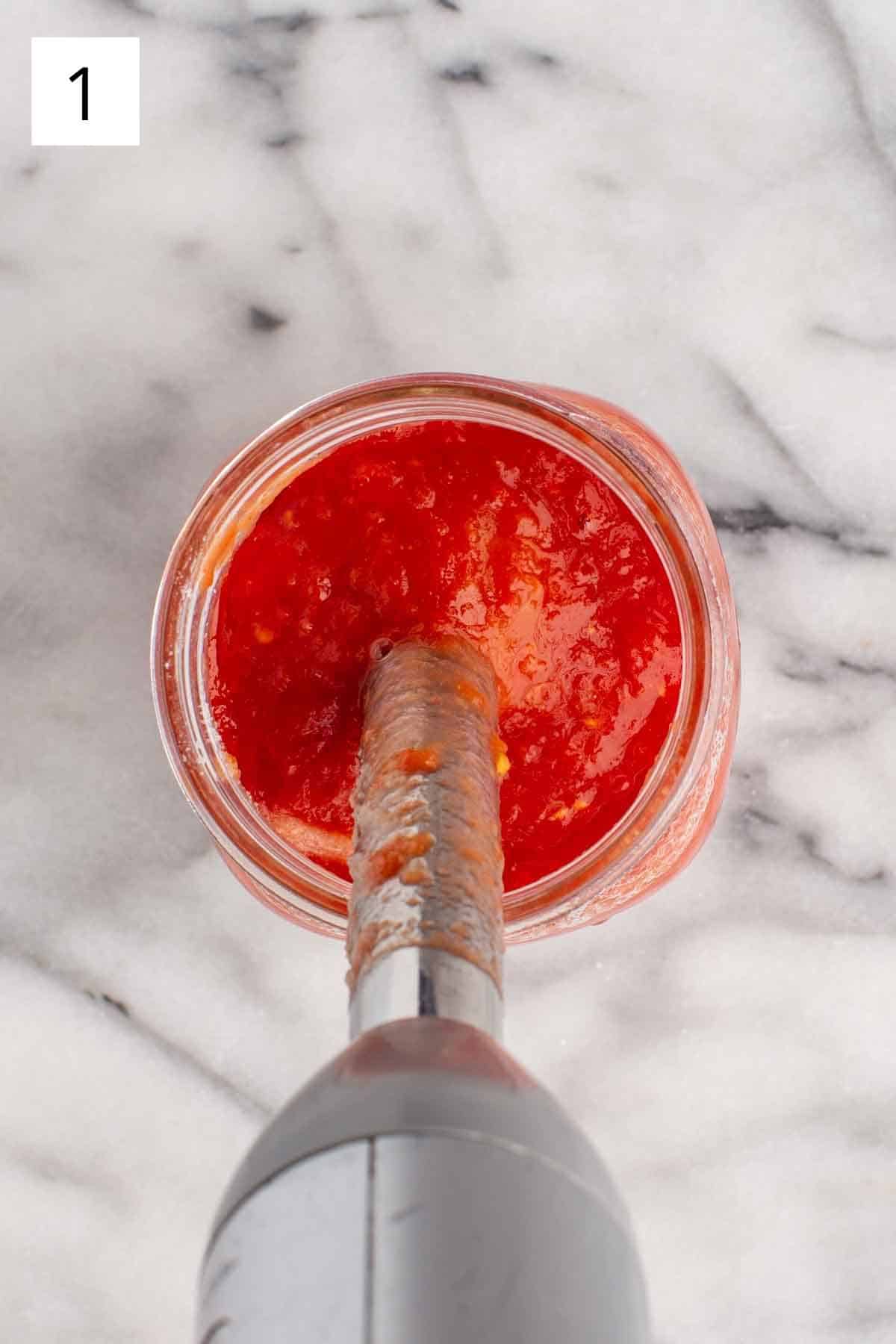 Making sauce with whole peeled tomatoes and an immersion blender.