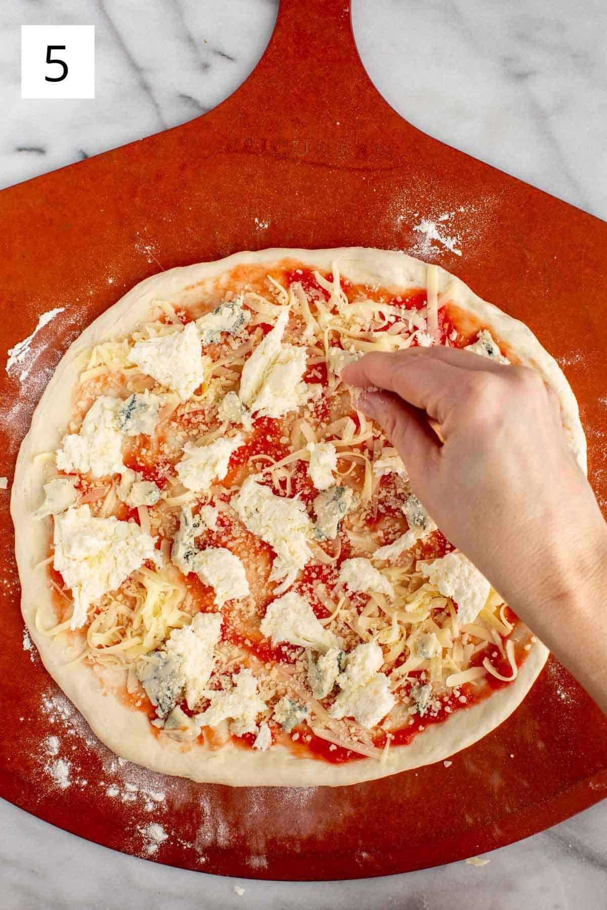 Adding 4 types of cheese to quattro formaggi pizza.