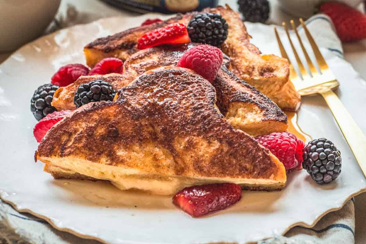 Mascarpone oozing out of French toast pieces.